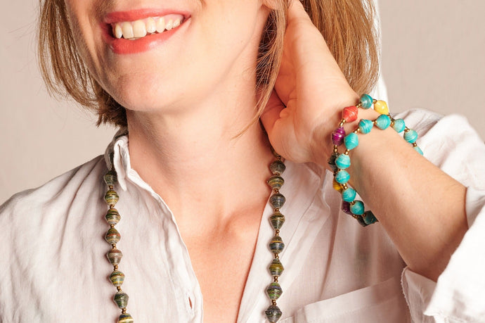Frau mit langer Papierperlenkette und zwei Armbändern